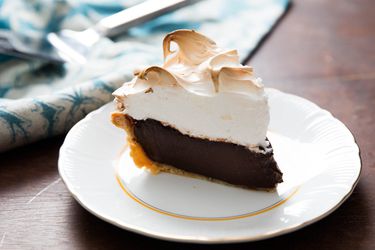 A slice of chocolate cream pie topped with vanilla meringue