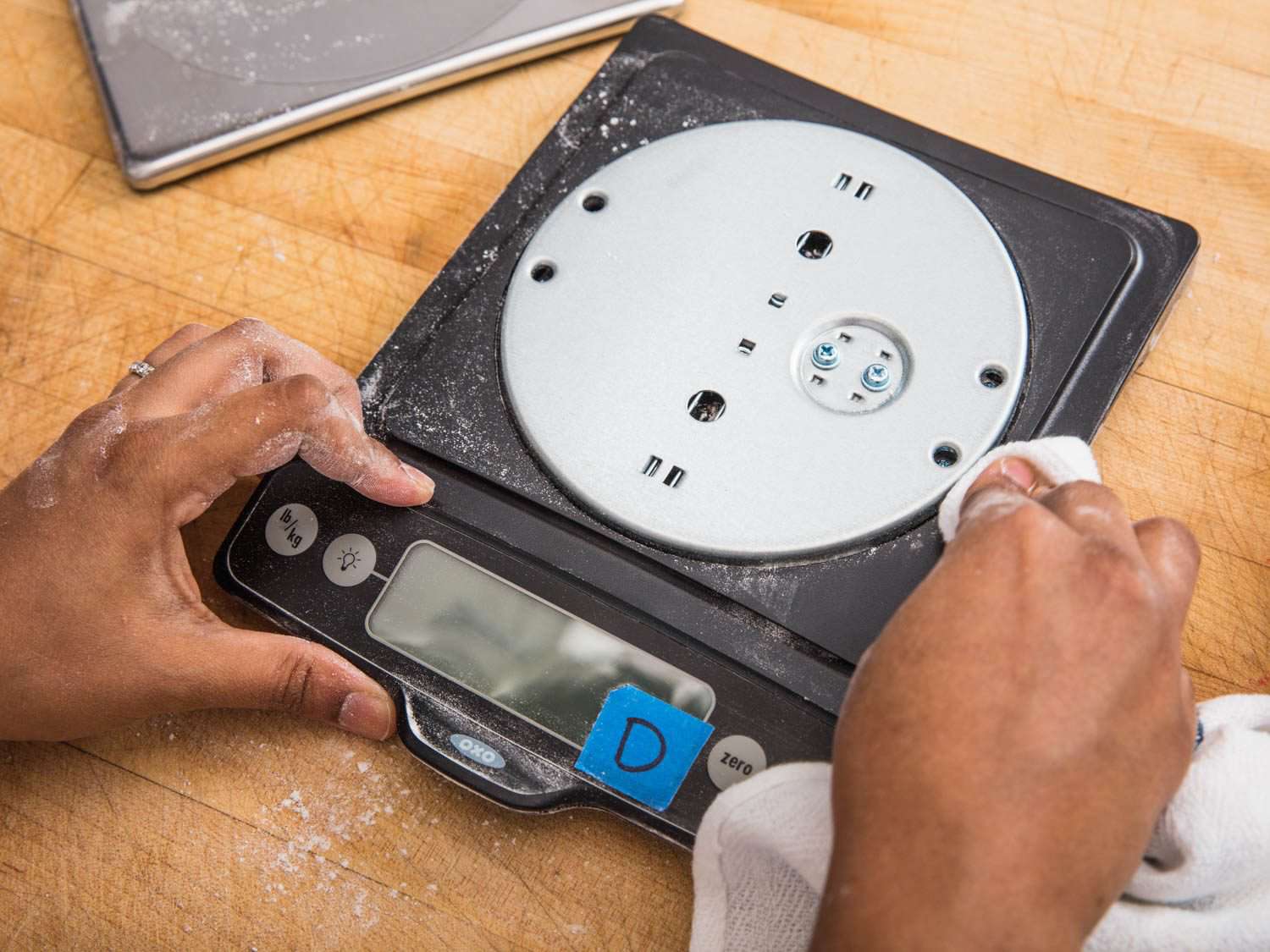 Cleaning the inside of a digital kitchen scale.