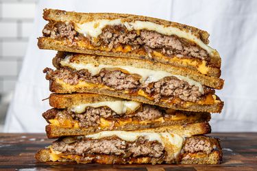 Stacked and sliced-in-half patty melts.