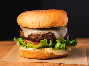 A juicy broiled burger with lettuce, tomato, cheese