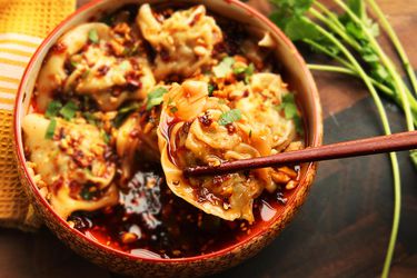 Bowl of Sichuan-style wontons in hot and sour vinegar and chili oil sauce