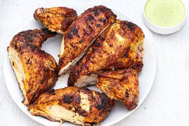 Peruvian-style grilled chicken with green sauce.