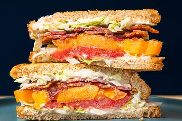 Two halves of a BLT stacked on top of each other