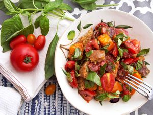 Panzanella salad with tomatoes and basil in a bowl.