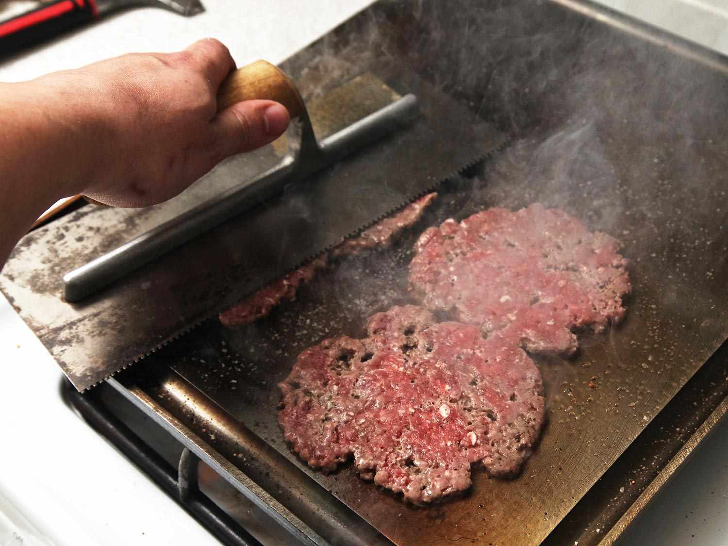 Pressing smashburgers on the baking steel griddle