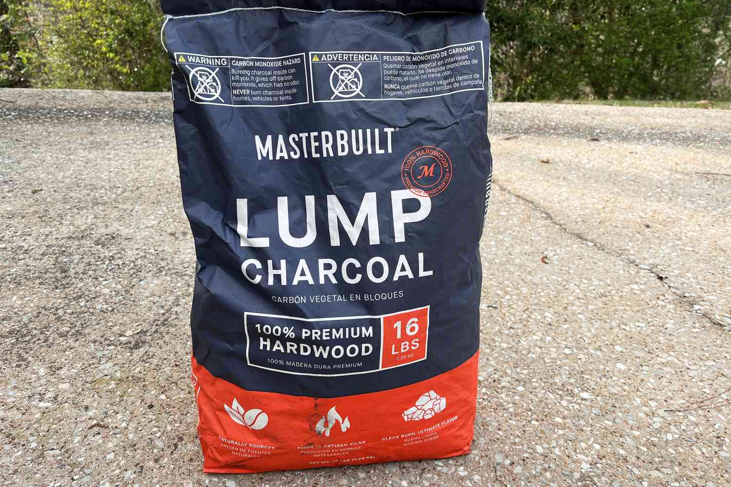 a bag of lump charcoal on a concrete surface