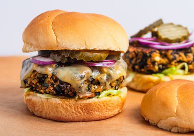 Black bean burgers with cheese, pickles, lettuce and red onions.
