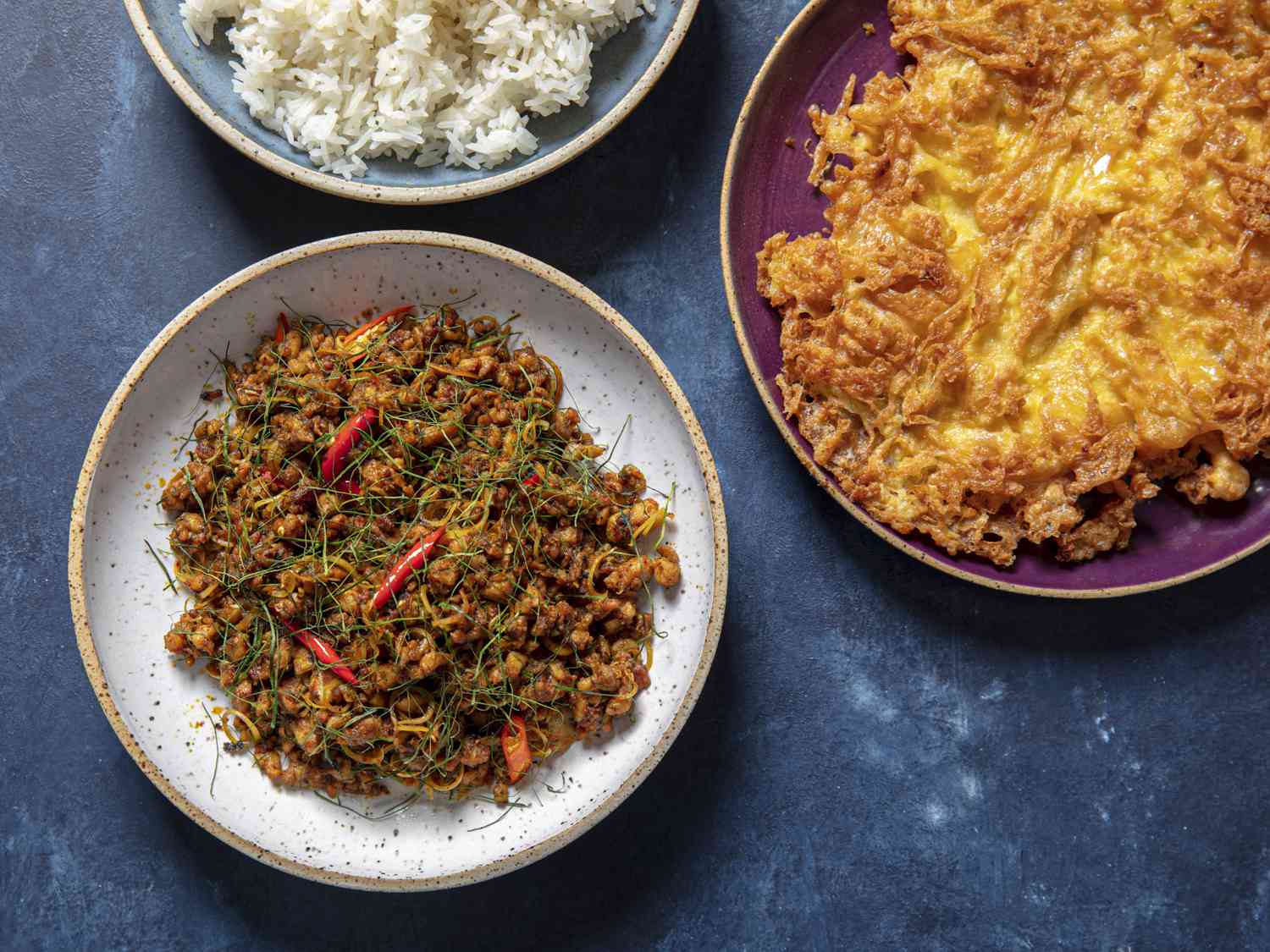 Khua Kling Gai，一碗米饭和泰式煎蛋，分别放在盘子里。