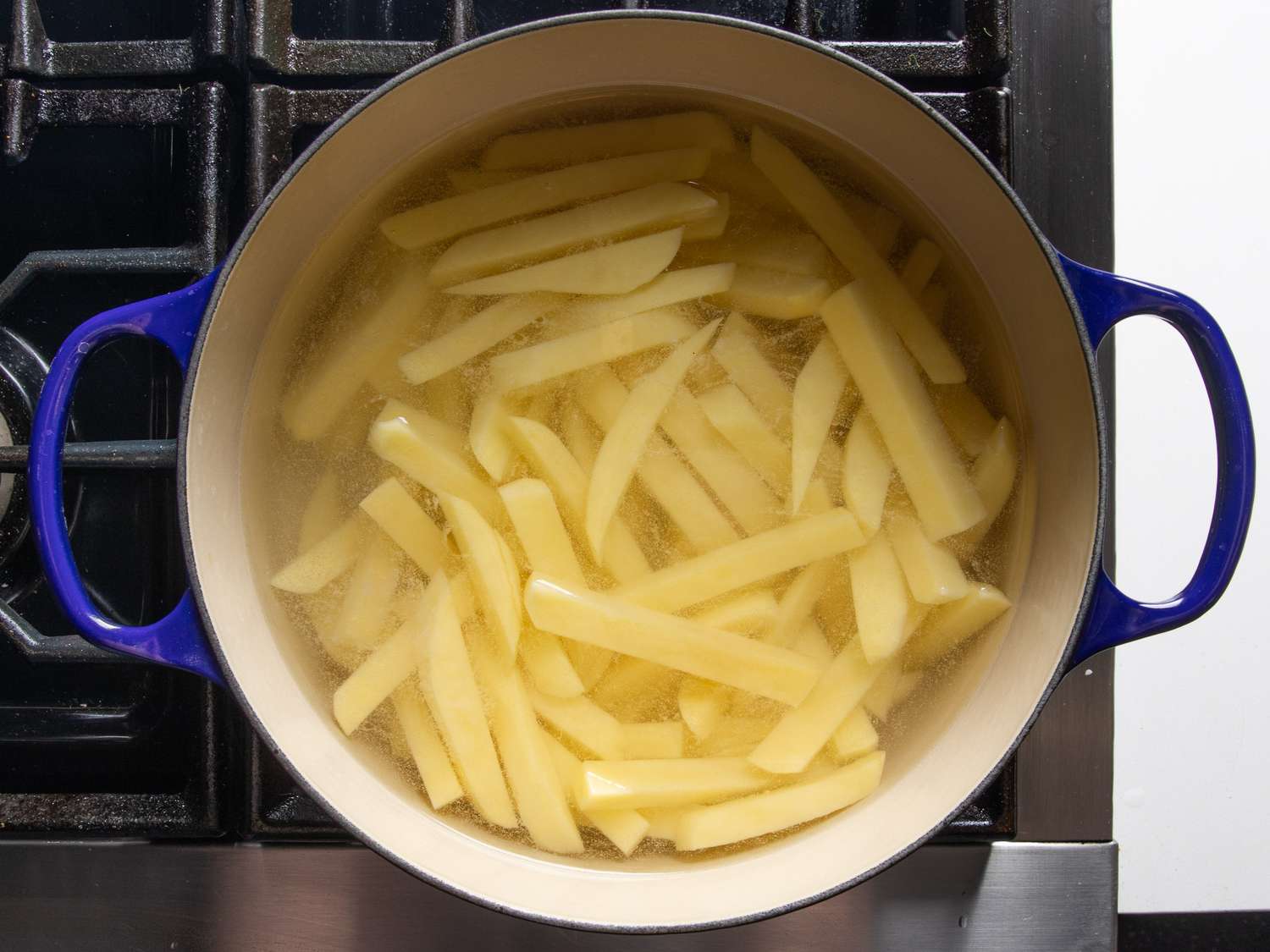 Par-cooking the fries in vinegary water.