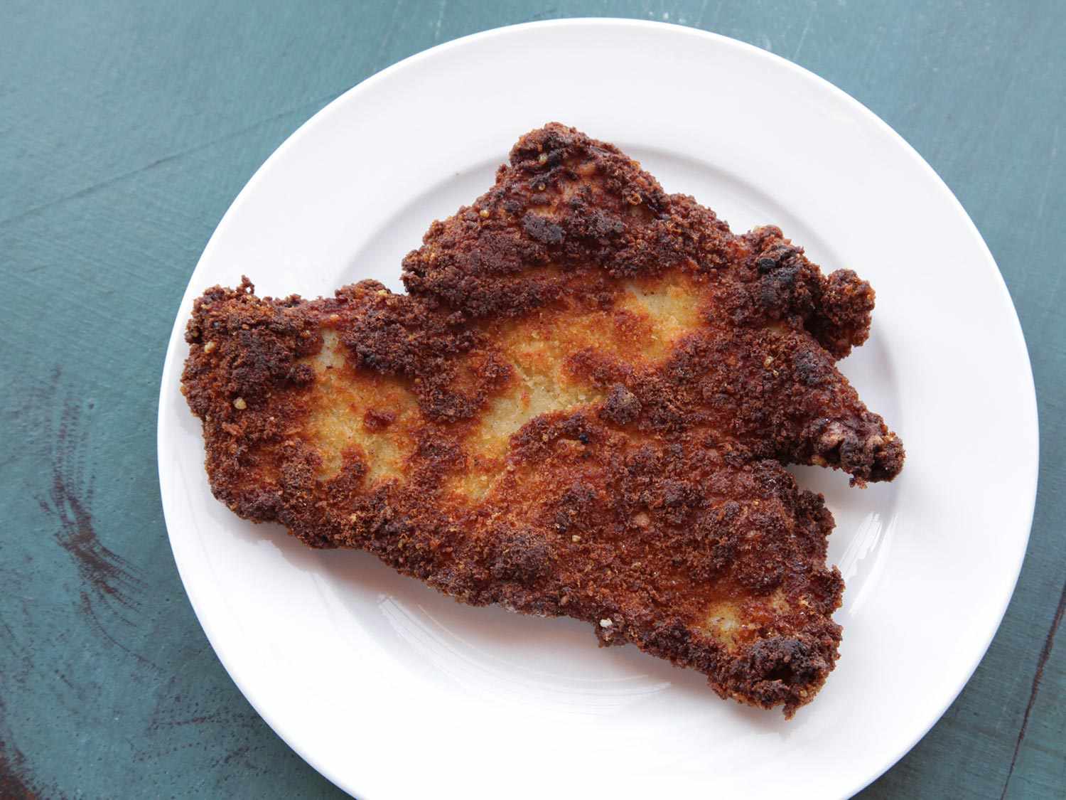 Breaded chicken breast with bits of burnt crust