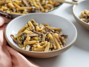 A bowl of creamy pasta with mushrooms