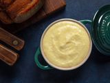 A small dish filled with smooth and buttery pommes puree.