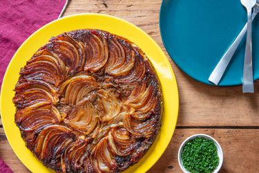 Overhead of a richly-golden French onion soup tarte tatin