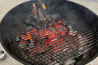 A closeup look at a fiery charcoal grill