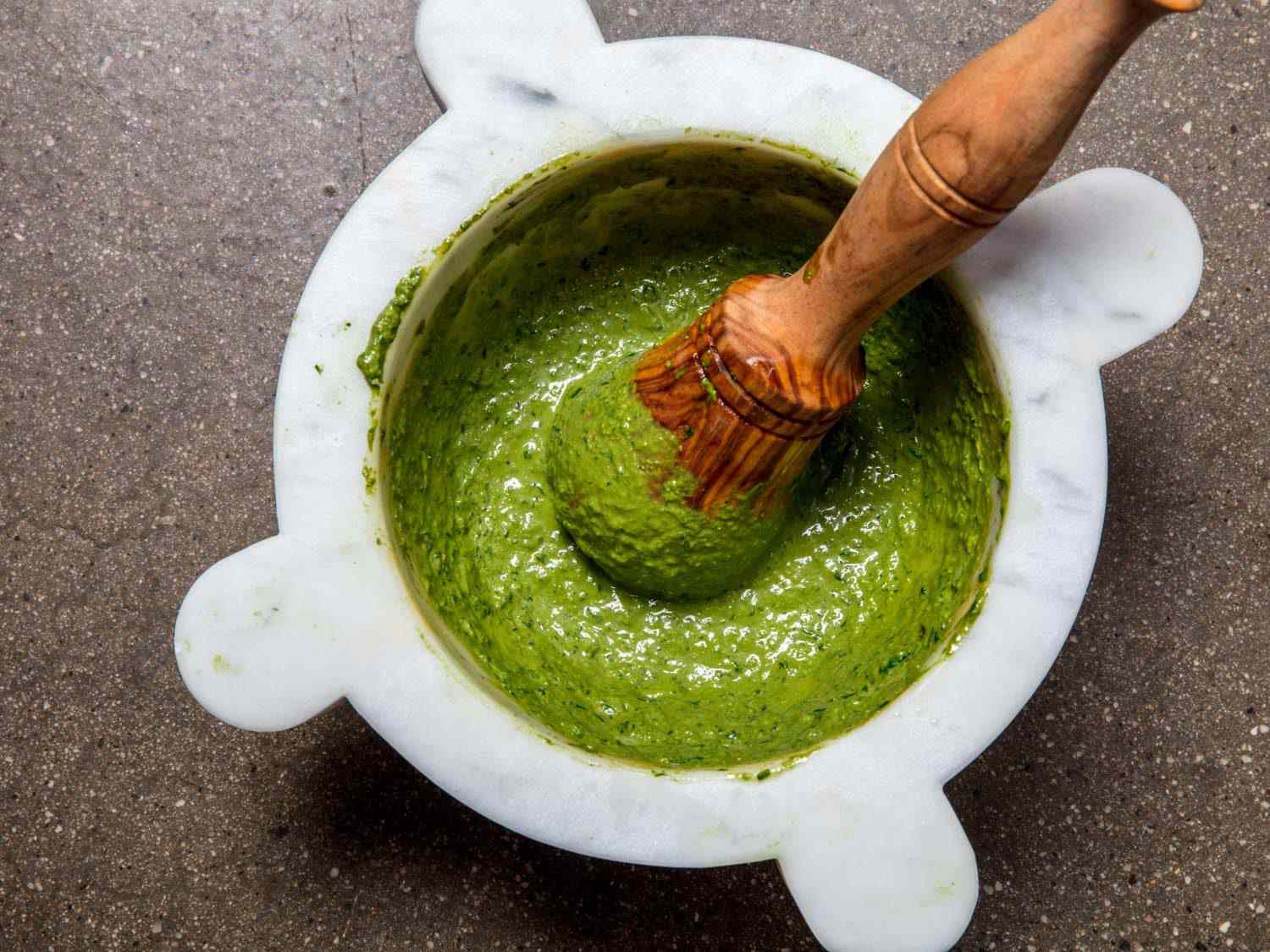 Finished pesto in a marble mortar and pestle