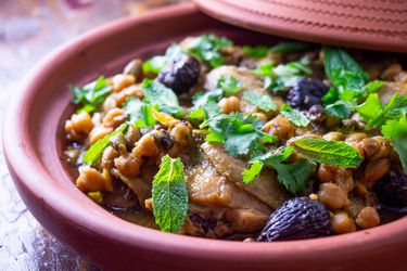 Chicken tagine with chickpeas and figs in an earthenware vessel
