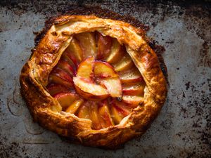 Overhead of a freeform peach galette with golden brown crust