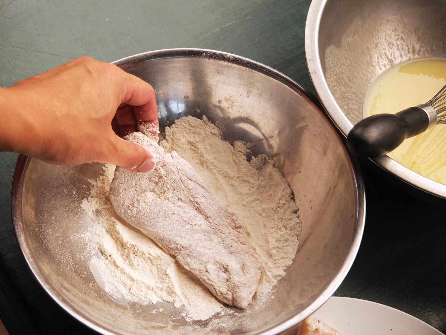 Dredging chicken breast in flour
