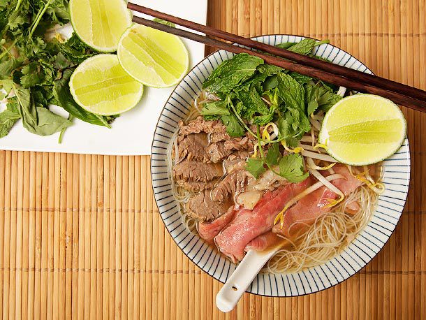 Top down view of a bowl of pho on the table.
