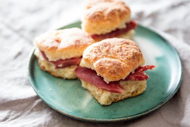 A plate of yeast-raised angel biscuits sandwiched with country ham