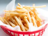 McDonald's-style thin and crispy french fries in plastic basket.