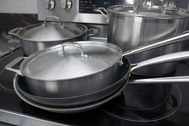 a variety of cookware on a stovetop