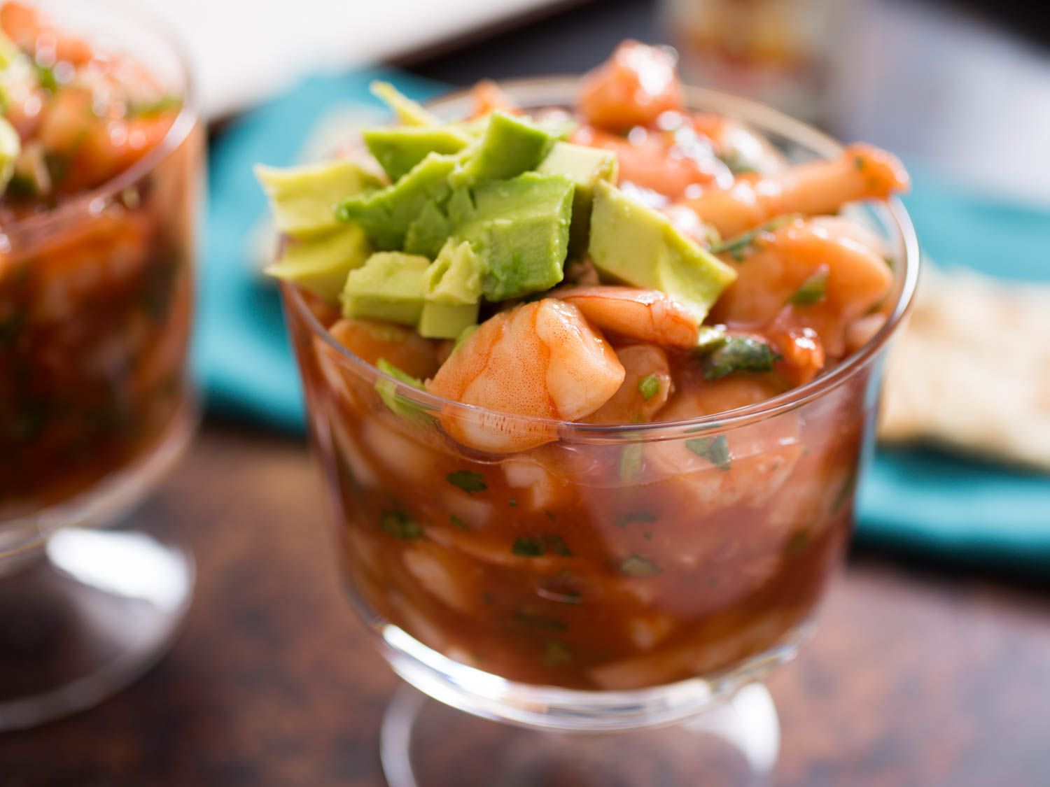 侧面的墨西哥虾鸡尾酒和牛油果丁在一个短的芭菲玻璃杯。