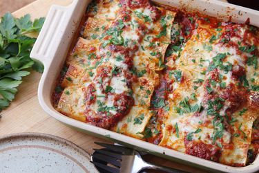 Overhead of spinach and ricotta manicotti baked in tomato sauce.