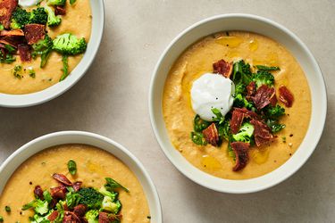 Three bowls of fully loaded vegan baked potato soup.