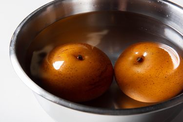 Frozen pears thawing in bowl of water