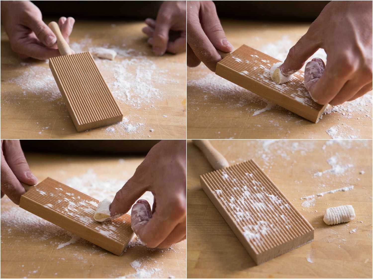 A hand rolling gnocchi on a gnocchi paddle.