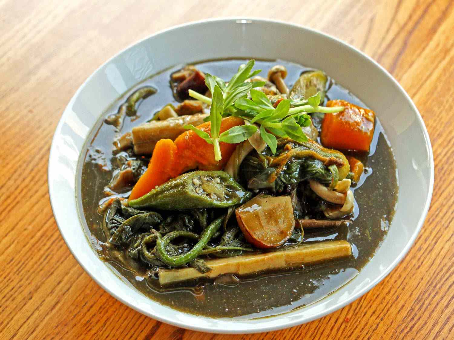 一碗gaeng naw mai:一种深绿色的汤，里面有竹笋、绿色的yanang叶和其他蔬菜和草药