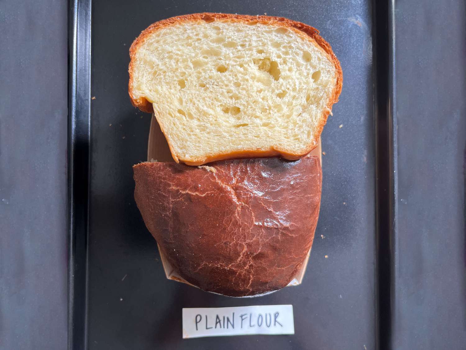 Overhead view of a cut brioche loaf made with plain flour