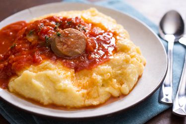 Smooth and creamy polenta topped with tomato sauce and sausage.