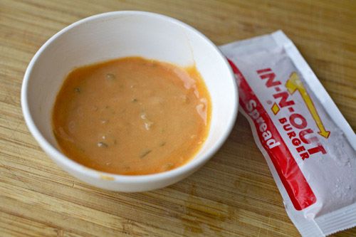A bowl of In-N-Out spread next to a packet.