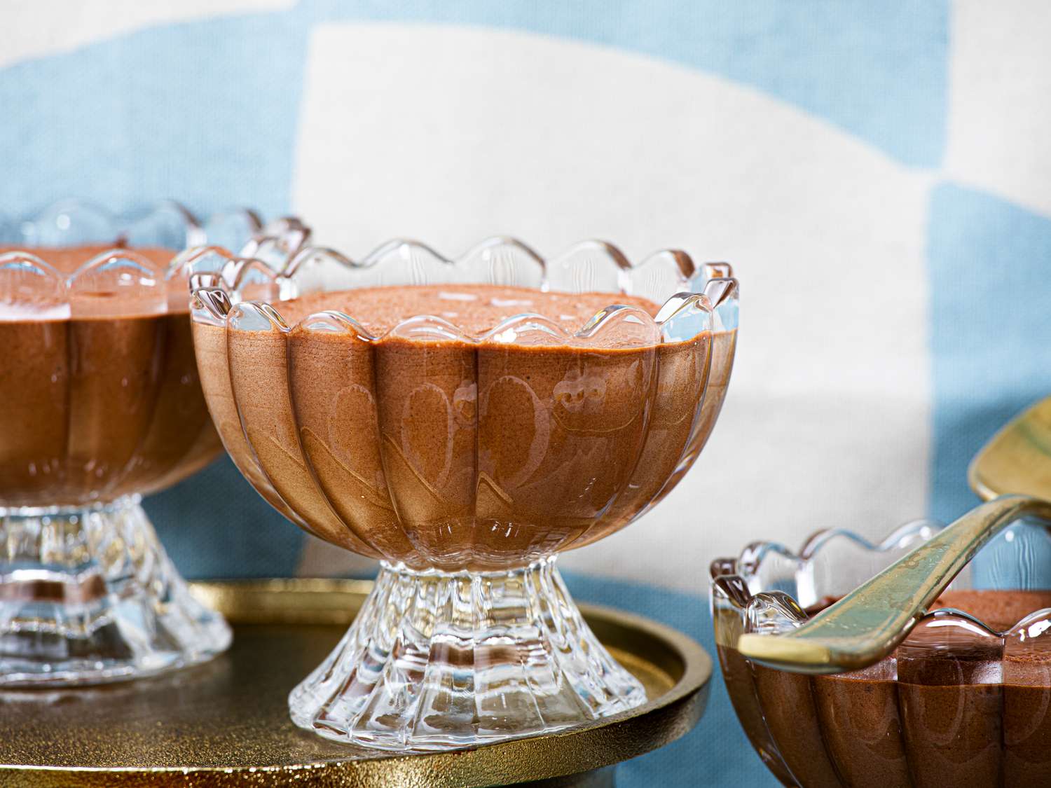 Side angle view of chocolate mousse in glass dessert bowls