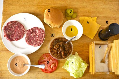 An overhead view of all of the components of a homemade Animal Style Double-Double burger from In-N-Out, with the ingredients numbered to correspond to the written list.