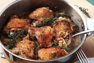 Braised chicken thighs in a stainless steel frying pan