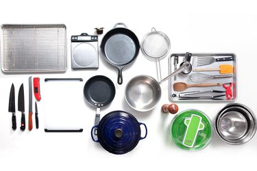 Overhead shot of essential kitchen equipment against white background
