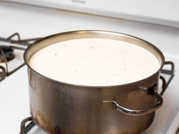 在炉子上放满冰淇淋蛋奶冻的金属锅。