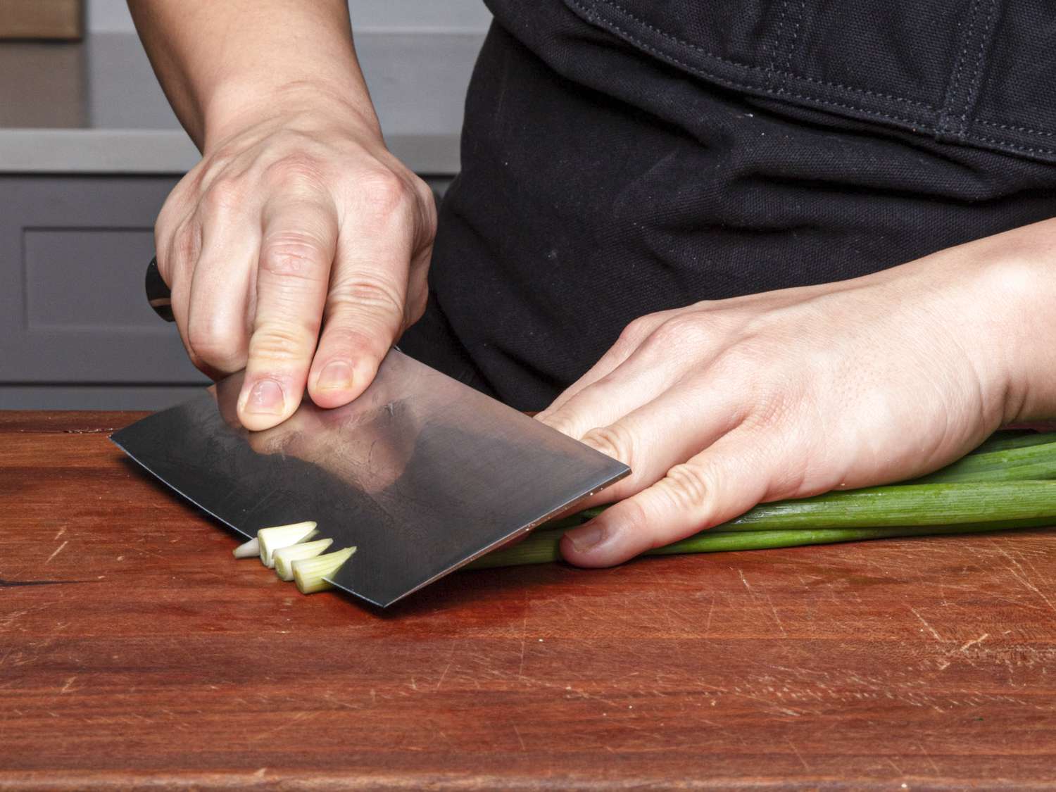 切葱花时要用反向倾斜法，即非惯用手的手指放在葱花上，形成决定切角的斜度;刀锋垂直于切菜板，角度略微向下。