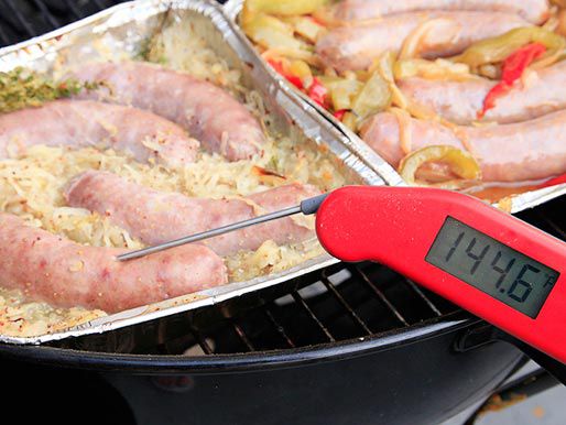 一个插在烤架上的香肠锅里的即时读数温度计