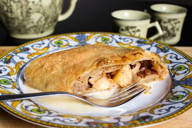 Apple strudel on a plate with a fork.
