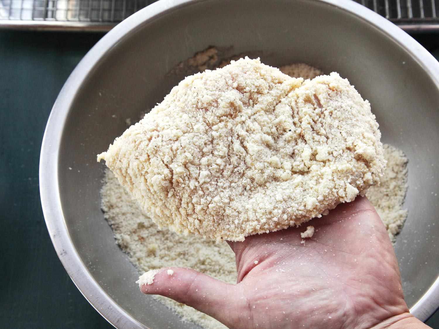 Hand-breading chicken breast