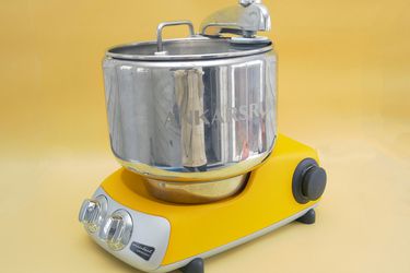 ankarsrum stand mixer on yellow background