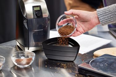 pouring out coffee grounds from the baratza virtuoso+