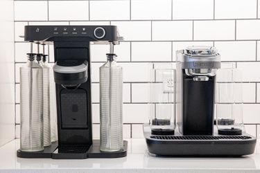 two cocktail machines side-by-side on a white surface