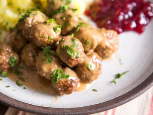 A plate with gravy-covered Swedish meatballs