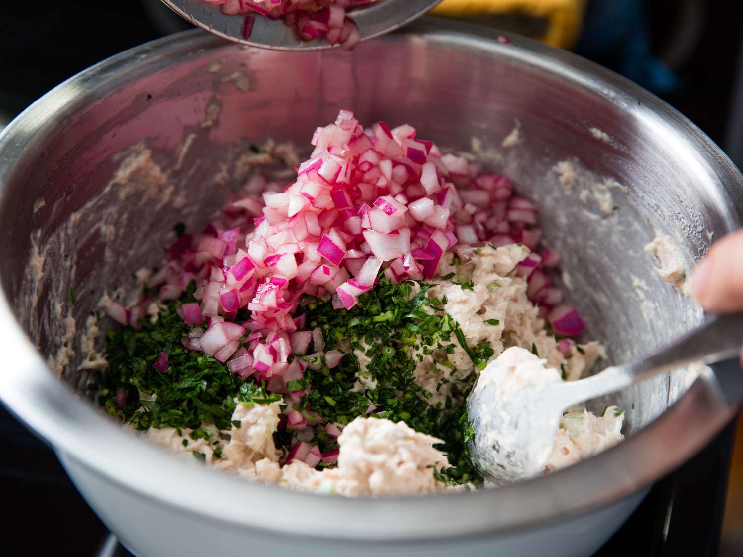 Pickled onion, parsley, and celery are added to the tuna mixture.