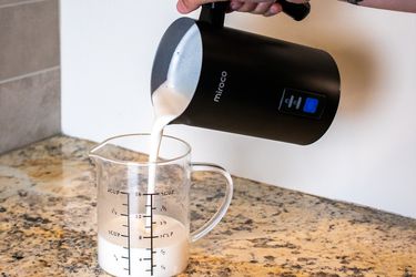 pouring oat milk from the miroco frother